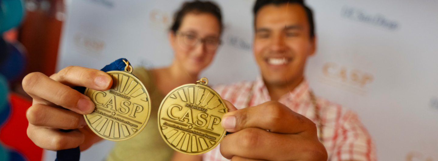 Casp students showing off their grad medals